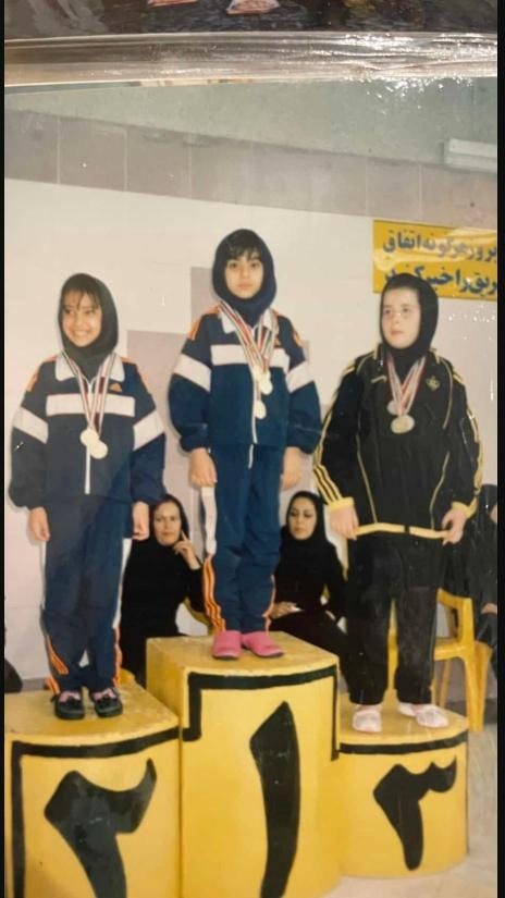 Fatemeh Naderi on the podium at a childhood swim meet